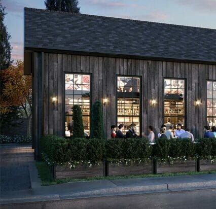 exterior patio of Greystones Restaurant with people dining by patio light at dusk