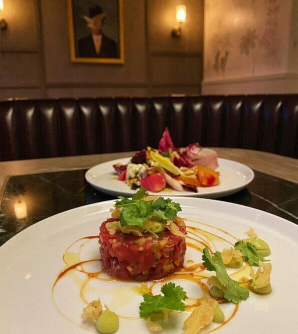 Two dishes of tuna tartar on white plates
