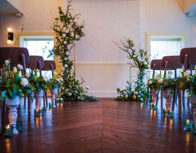 Wedding ceremony setup with floral aisle and chairs