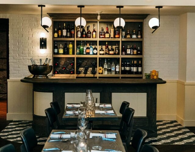 Bar and dining area with wine display and seating