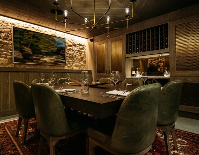 Private dining room with chandelier and long table